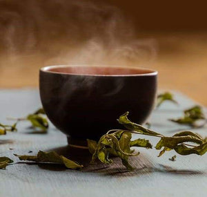 bowl of steaming herbal facial tea for detoxifying and purifying pores